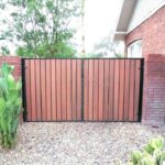 Wrought iron panel and wood pickets Fence