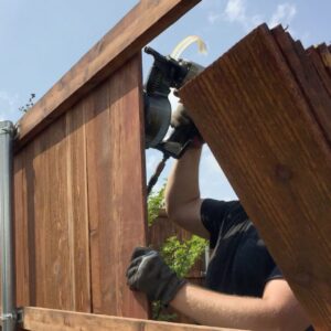 someone putting up a a fence